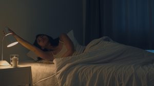 Beautiful Asian young woman sleeping cozily in her bedroom. Indi