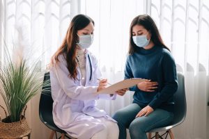 asian-doctor-visit-examines-young-adult-woman-hospital-with-stomach-ache-doctor-checking-up-consulting-health-care-wearing-mask-protect-covid19-pandemic_640221-118