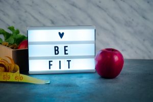 shiny-love-be-fit-inscription-board-with-apple_23-2148035066